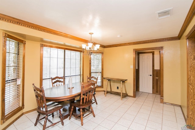 dining space with crown molding, a notable chandelier, and light tile patterned flooring