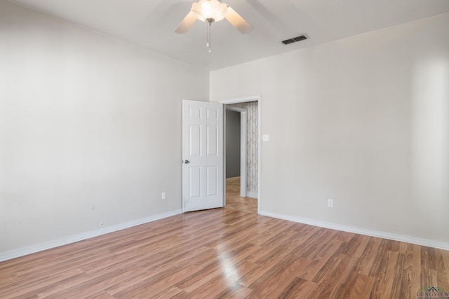 spare room with light hardwood / wood-style flooring and ceiling fan