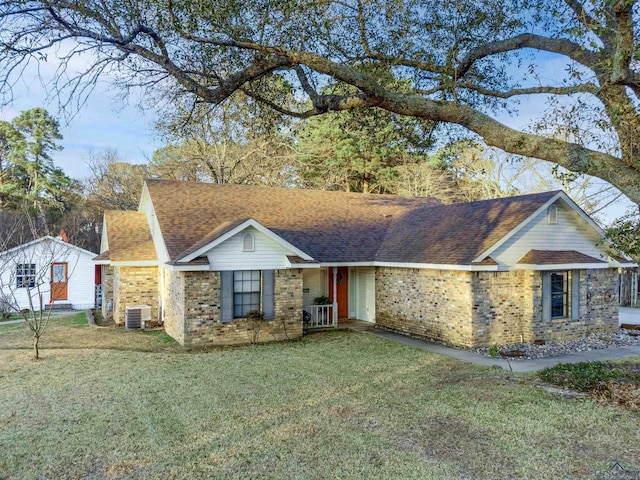 single story home with a front yard and central AC unit