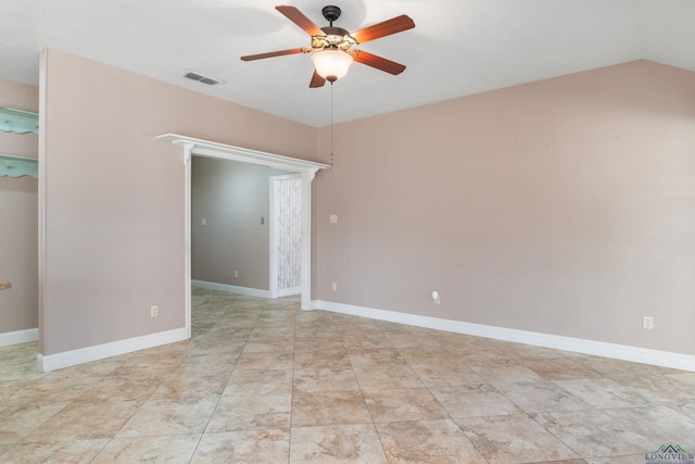 spare room with ceiling fan and vaulted ceiling