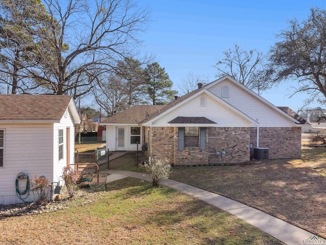 view of front facade with central AC unit and a front lawn