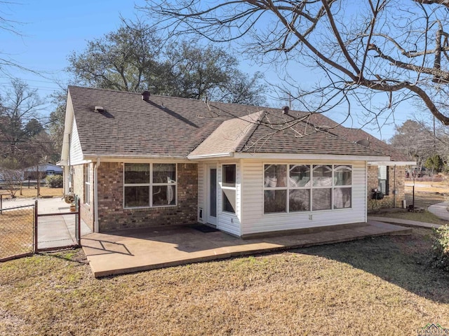 back of house featuring a yard and a patio area