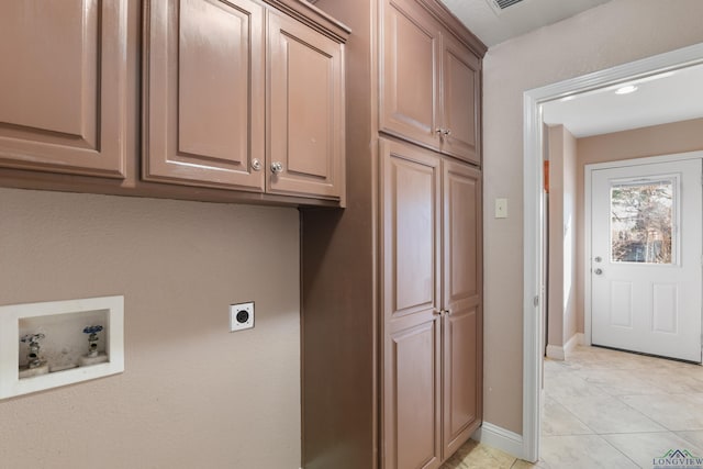 clothes washing area featuring cabinets, washer hookup, hookup for an electric dryer, and light tile patterned floors