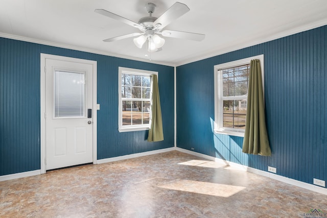 unfurnished room with crown molding, a wealth of natural light, and ceiling fan