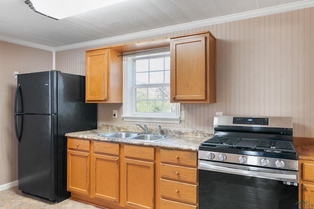 kitchen featuring black refrigerator, crown molding, stainless steel gas range, and sink