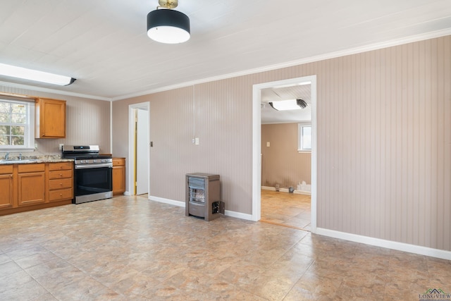 kitchen with ornamental molding, sink, heating unit, and stainless steel range with gas stovetop