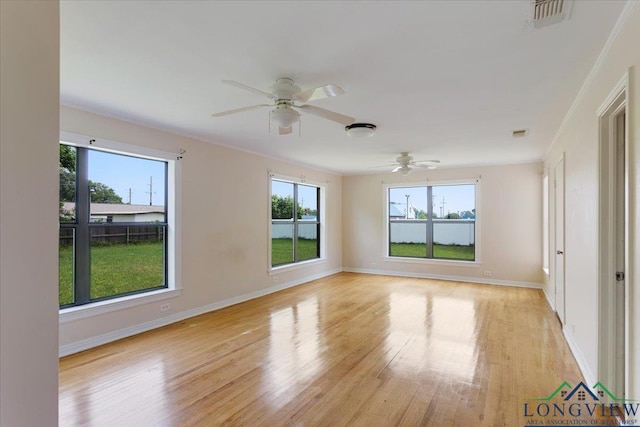 104 Mackinnon St, Mount Pleasant, TX 75455 - unfurnished room with plenty of natural light, ceiling fan, light wood-type flooring, and baseboards