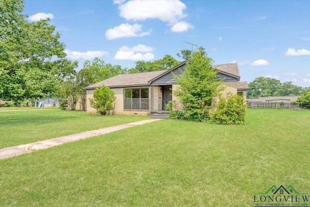 104 Mackinnon St, Mount Pleasant, TX 75455 - view of front facade with a front yard and brick siding