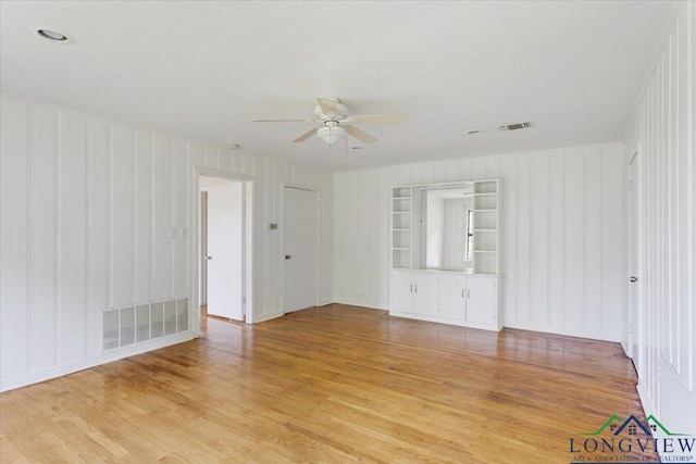 104 Mackinnon St, Mount Pleasant, TX 75455 - spare room with light wood-style floors, ceiling fan, and a decorative wall