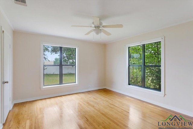 104 Mackinnon St, Mount Pleasant, TX 75455 - spare room with healthy amount of natural light, wood finished floors, crown molding, and baseboards