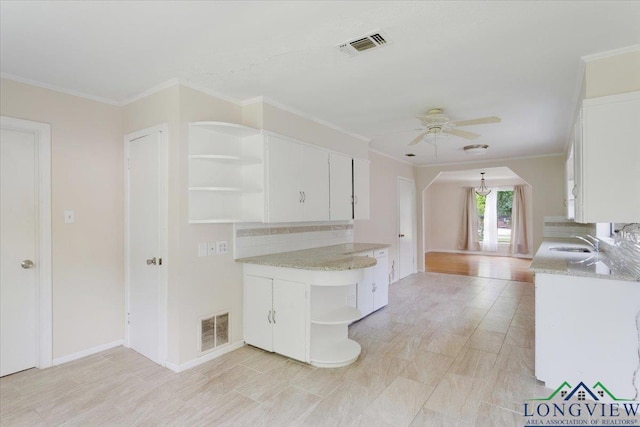 104 Mackinnon St, Mount Pleasant, TX 75455 - kitchen featuring open shelves, a sink, a ceiling fan, white cabinets, and crown molding