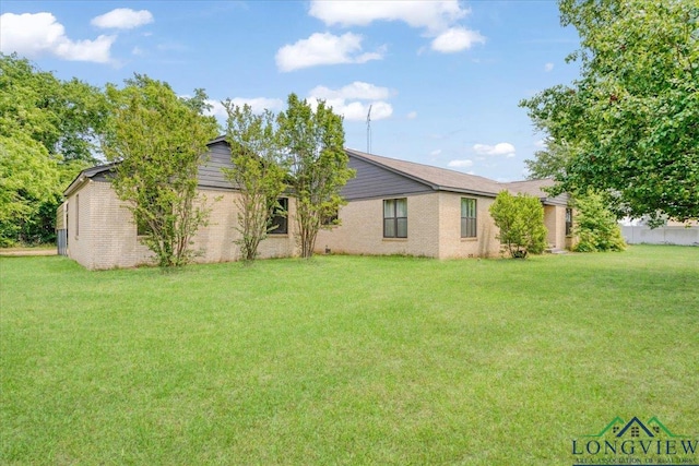 104 Mackinnon St, Mount Pleasant, TX 75455 - view of front of property featuring a front yard and brick siding