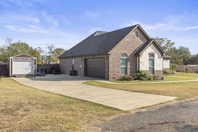 view of front of property featuring an outbuilding, a front yard, and a garage