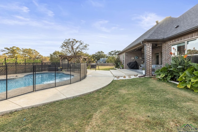 view of swimming pool featuring a lawn, area for grilling, a pergola, and a patio