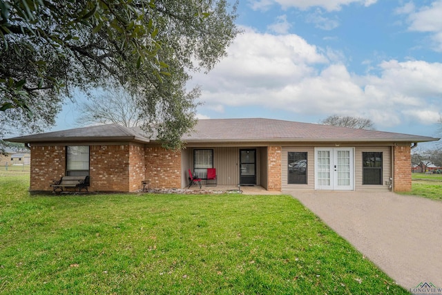 single story home featuring a front yard and french doors