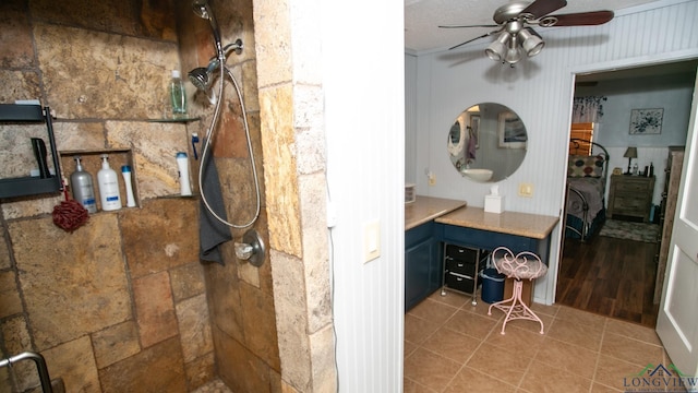 bathroom featuring tile patterned flooring, ceiling fan, a shower, and a textured ceiling