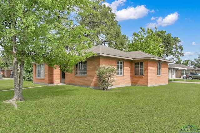 202 W Rocky Creek Rd, Houston, TX 77076 - view of side of property with brick siding and a lawn