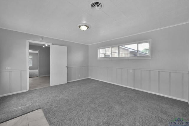 202 W Rocky Creek Rd, Houston, TX 77076 - carpeted empty room with wainscoting, a decorative wall, and crown molding