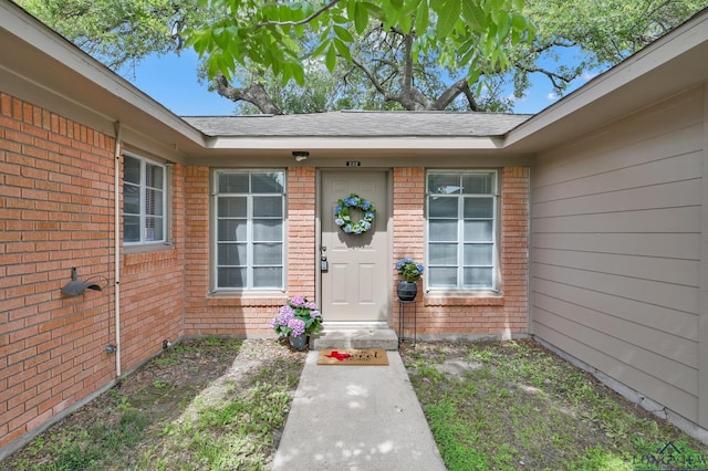 202 W Rocky Creek Rd, Houston, TX 77076 - property entrance featuring brick siding and a shingled roof
