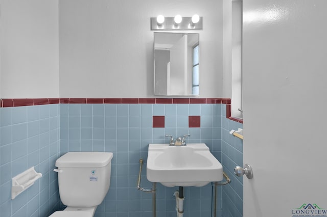 202 W Rocky Creek Rd, Houston, TX 77076 - half bath with toilet, wainscoting, tile walls, and a sink