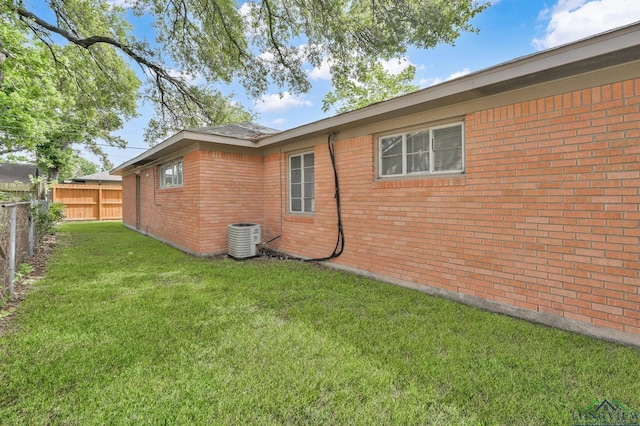 202 W Rocky Creek Rd, Houston, TX 77076 - view of side of property featuring brick siding and central AC