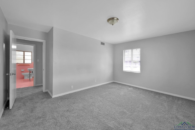202 W Rocky Creek Rd, Houston, TX 77076 - empty room featuring carpet and baseboards