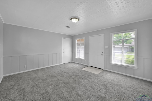 202 W Rocky Creek Rd, Houston, TX 77076 - carpeted entryway with ornamental molding, a wainscoted wall, and a decorative wall