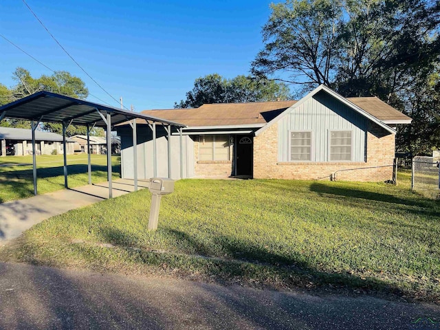 view of front of property with a front lawn and a carport