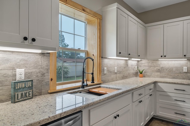 9089 Raspberry Ave, Frankston, TX 75763 - kitchen with a sink, white cabinetry, backsplash, light stone counters, and stainless steel dishwasher