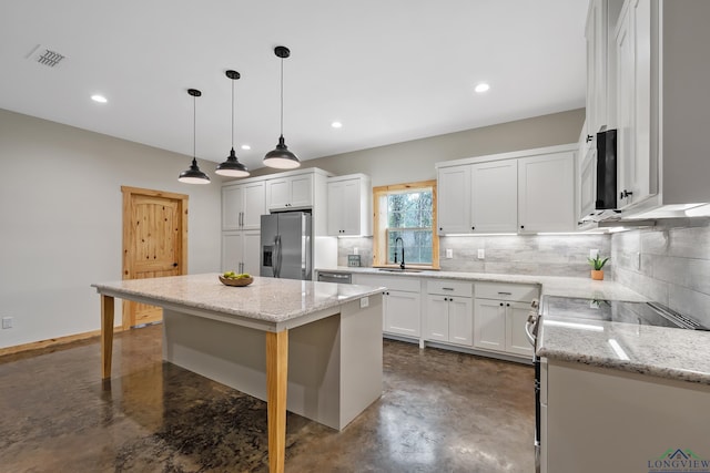 9089 Raspberry Ave, Frankston, TX 75763 - kitchen with stainless steel appliances, a sink, concrete flooring, tasteful backsplash, and recessed lighting