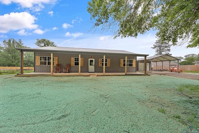 9089 Raspberry Ave, Frankston, TX 75763 - view of front facade with a carport, metal roof, covered porch, and board and batten siding