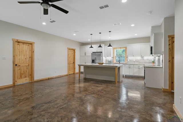 9089 Raspberry Ave, Frankston, TX 75763 - kitchen featuring stainless steel fridge, ceiling fan, white cabinets, baseboards, and tasteful backsplash