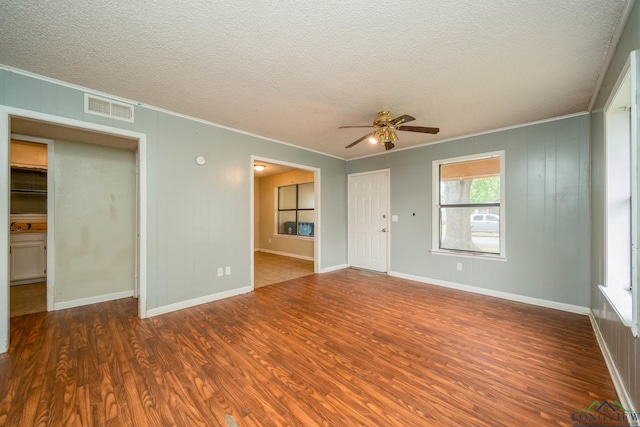 308 N Lee Dr, Gladewater, TX 75647 - spare room featuring wood finished floors, crown molding, a ceiling fan, and a textured ceiling