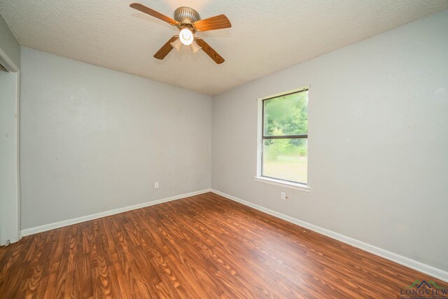 308 N Lee Dr, Gladewater, TX 75647 - empty room featuring wood finished floors, ceiling fan, and a textured ceiling