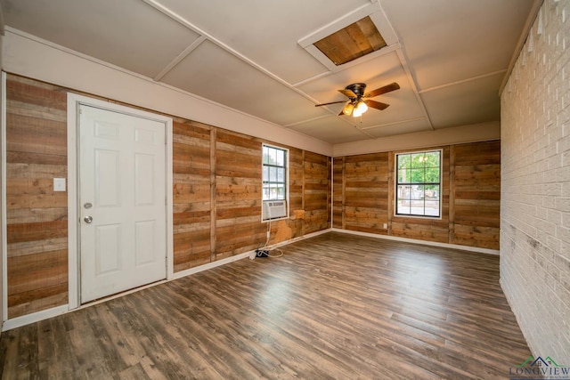 308 N Lee Dr, Gladewater, TX 75647 - spare room featuring wood walls, wood finished floors, ceiling fan, and cooling unit