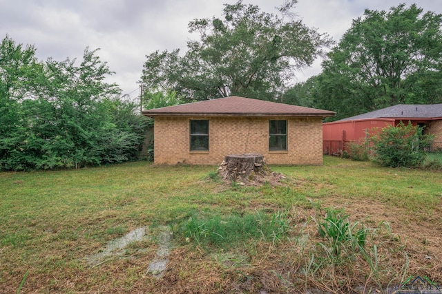 308 N Lee Dr, Gladewater, TX 75647 - back of property featuring a yard and brick siding