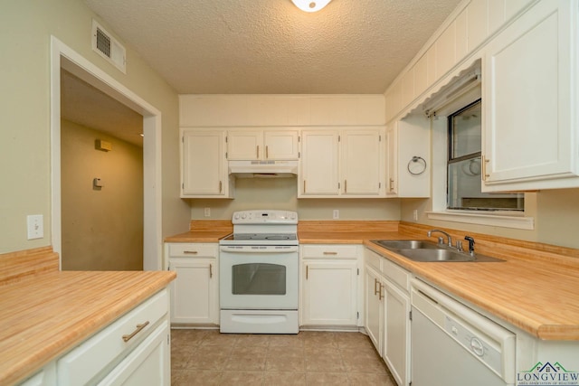 308 N Lee Dr, Gladewater, TX 75647 - kitchen with white appliances, under cabinet range hood, light countertops, white cabinetry, and a textured ceiling