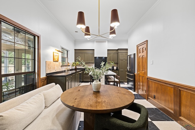6307 Shady Oaks Dr, Tyler, TX 75703 - dining area featuring wainscoting, crown molding, and a chandelier