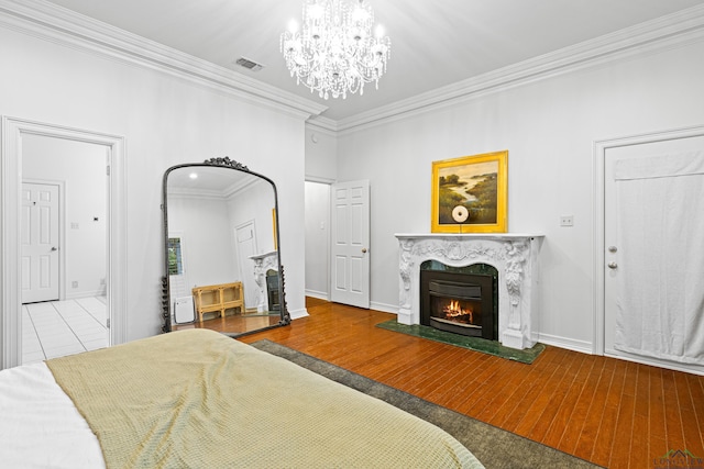 6307 Shady Oaks Dr, Tyler, TX 75703 - bedroom with ornamental molding, a high end fireplace, a chandelier, baseboards, and wood finished floors