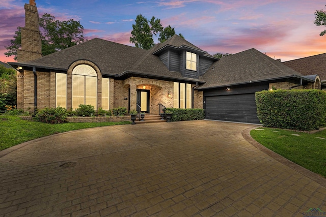 6307 Shady Oaks Dr, Tyler, TX 75703 - french provincial home with brick siding, a garage, decorative driveway, roof with shingles, and a chimney