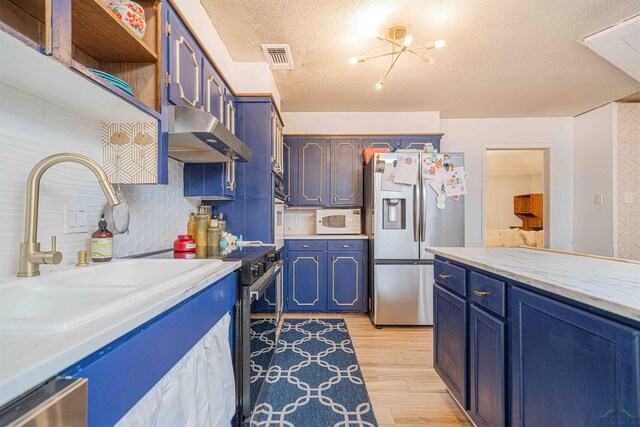 kitchen with stainless steel fridge with ice dispenser, light countertops, white microwave, a textured ceiling, and blue cabinetry