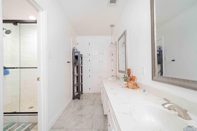 full bath featuring ornamental molding, a sink, visible vents, and a stall shower
