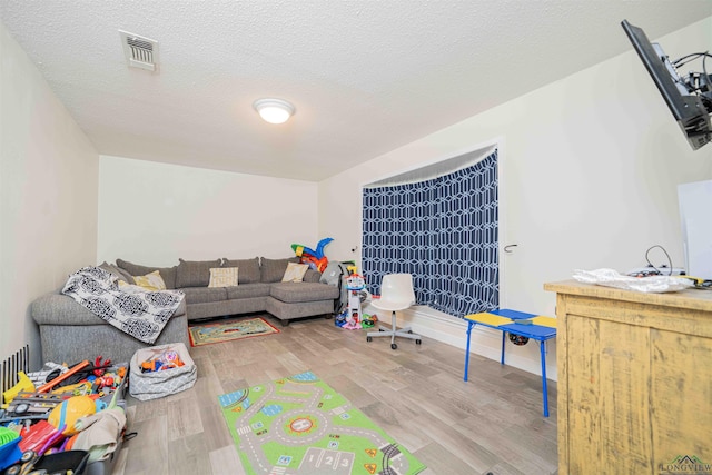 game room with wood finished floors and visible vents