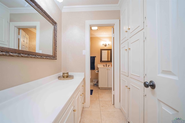 bathroom with crown molding, tile patterned floors, and vanity
