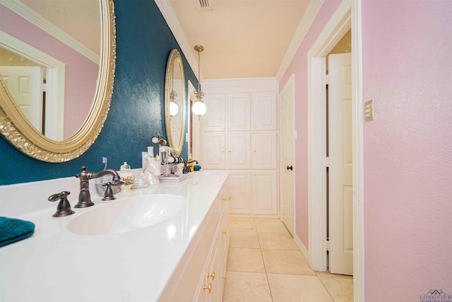 bathroom featuring crown molding, double vanity, tile patterned flooring, and a sink