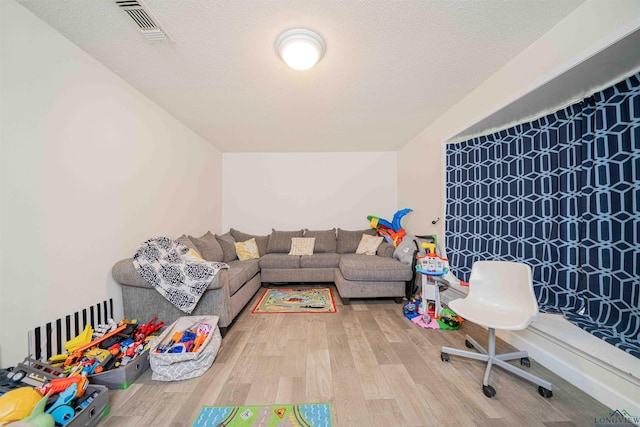 game room featuring wood finished floors and visible vents