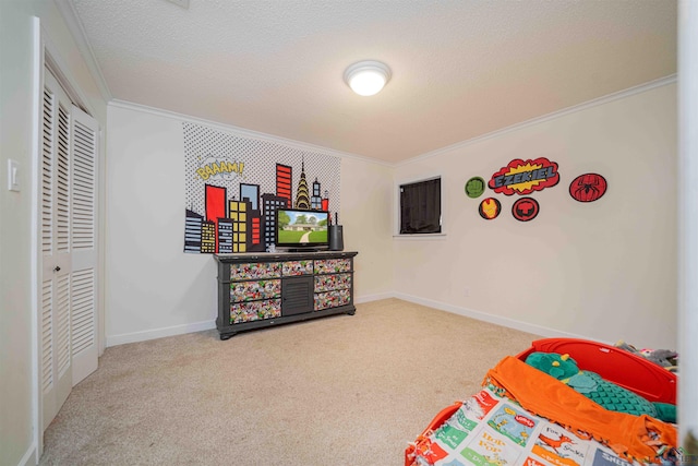 carpeted bedroom featuring baseboards, ornamental molding, a textured ceiling, and a closet