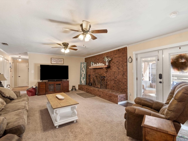 living room with visible vents, a fireplace, crown molding, and carpet floors