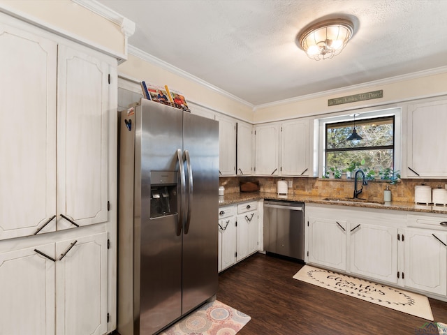 kitchen featuring tasteful backsplash, appliances with stainless steel finishes, crown molding, and a sink