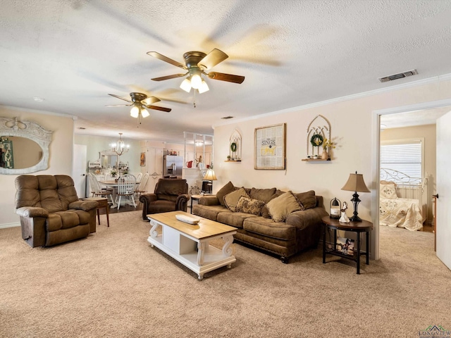 living room with ornamental molding, carpet, visible vents, and a textured ceiling